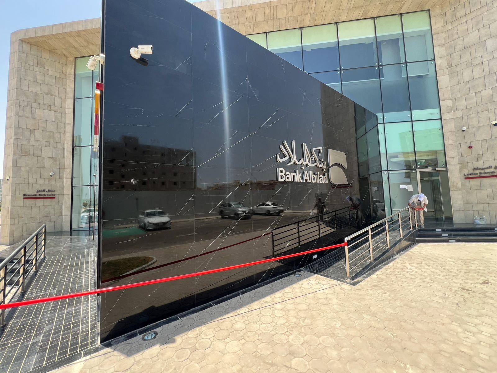 Real-world UAE application reference on the marble façade of a bank building